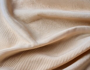 Close-up of beige woven fabric texture showing detailed knit pattern and soft material.