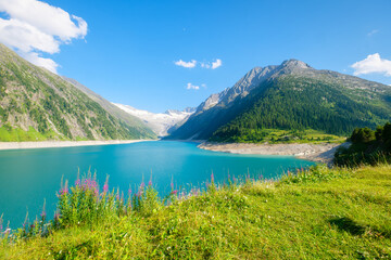 Azure lake and high mountain range in Austria. Mountain landscapes during summer. Warm sunny...