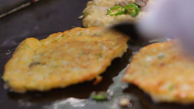 Mung bean pancake flipped over on an iron plate