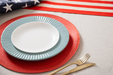 Table setting for USA Independence Day. Festive dinner with empty plate and decoration in USA national flag colors. Happy Memorial Day. Close up.