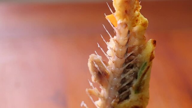 Shreding pollack pancakes by hand