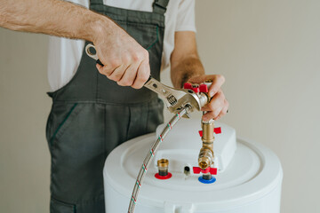 Man fixing water heater using wrench