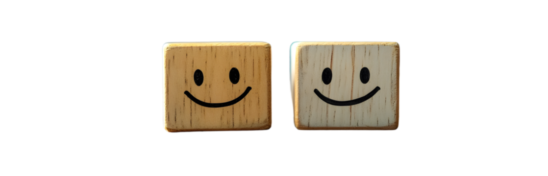 A Wooden Cube Features A Smiling Face On One Side And An Unhappy Face On The Other For A Positive Mindset Selection.
