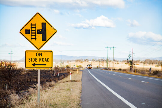 Naklejki Train track crossing on side road sign on rural road