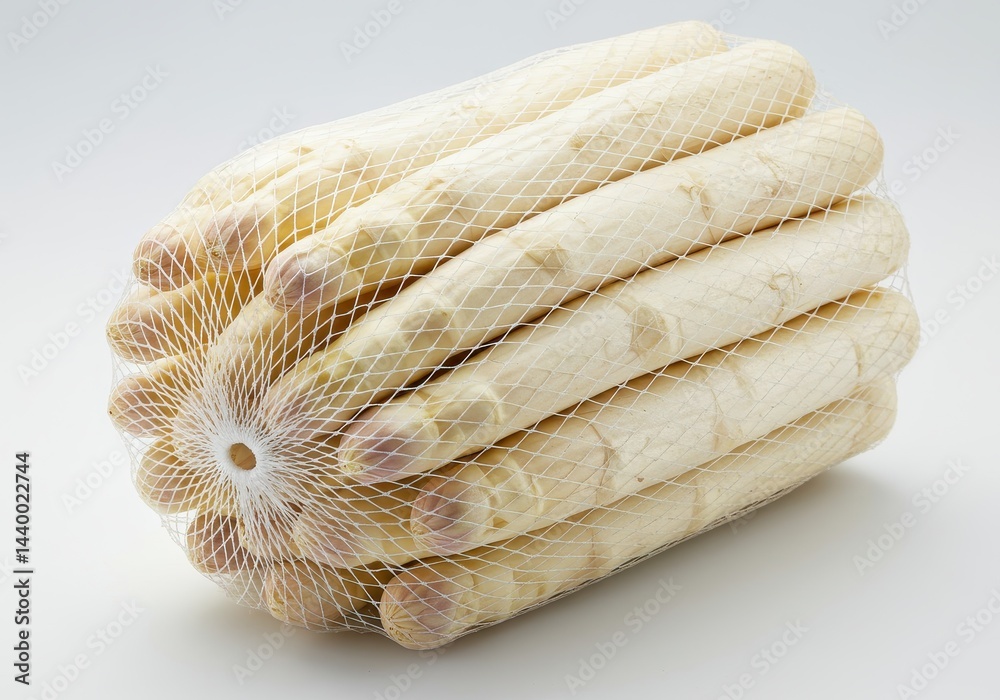Wall mural a bundle of white asparagus spears in a net bag on a white background in a studio setting
