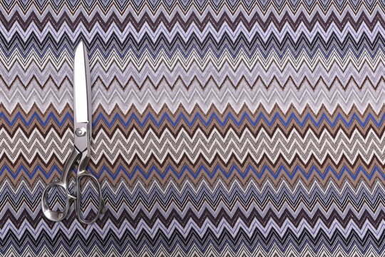 Top-down view of Missoni knit fabric showcasing its intricate texture and vibrant woven pattern. The premium material, known for its elasticity and elegance, is ideal for high-fashion garments.