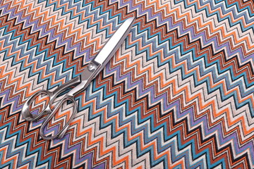 Top-down view of Missoni knit fabric showcasing its intricate texture and vibrant woven pattern....