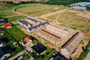 Aerial view of large housing estate under construction with modern residential buildings in small...