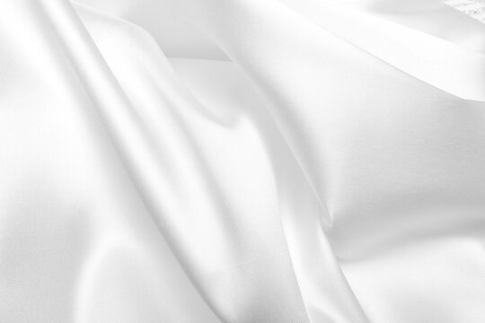 Closeup of white bridal mikado brocade satin. Perfect for creating elegant wedding white backgrounds.