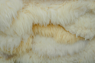 Close-up of a stack of white sheepskins