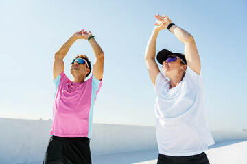 Energizing morning stretch on a sunny rooftop with dedicated joggers enjoying fitness together
