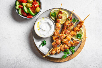 Meat kebabs, skewers with yogurt sauce and  fresh vegetable salad