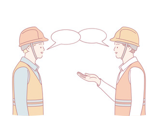 Two construction workers in helmets and vests discuss important details about their current project