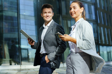Business professionals networking in a modern urban environment during a sunny afternoon