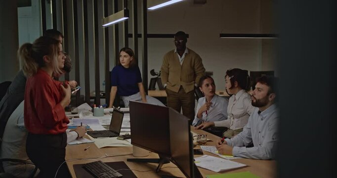 Diverse team of business professionals collaborating on a project in a modern office, discussing strategies and ideas during a productive meeting.