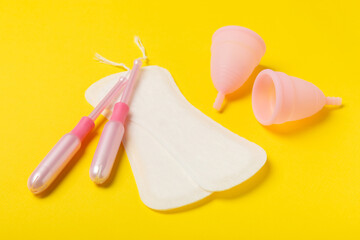 Menstrual cup on a bright background. Sanitary napkins, tampons and menstrual cup.Concept of critical days, menstruation.feminine hygiene product. Women health concept.Premenstrual syndrome.Copy space