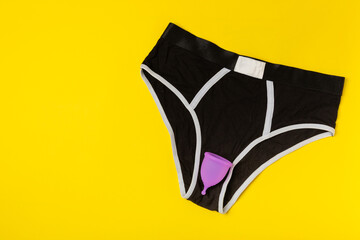 Menstrual cup on a bright background. Sanitary napkins, tampons and menstrual cup.Concept of...