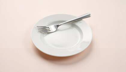 Empty plate with fork on a soft pink background  