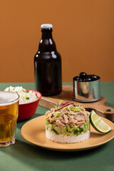 Tinned tuna salad on a plate with beer rice and other snacks in a modern interior, food art