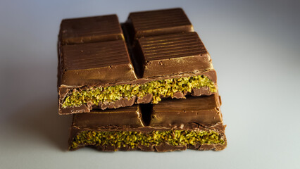 dubai chocolate with pistachio cream filled center. sliced and stacked for presentation. macrophotography close-up background