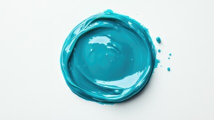 A small, teal-colored circular object with a subtle design or mark on its surface,  a circular blob of vibrant teal paint,  reflecting light to highlight its wet and shiny texture.