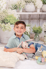 little boy with an easter outfit and a stuffed bunny 