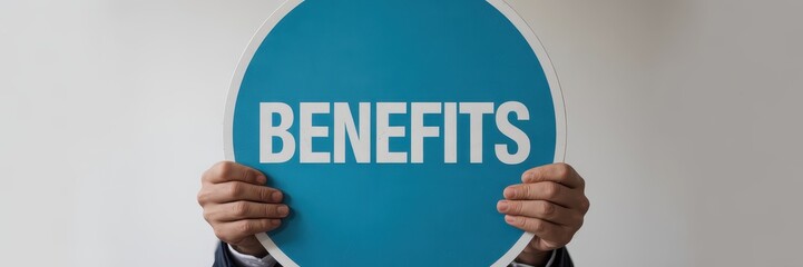 Hands holding a benefits sign.