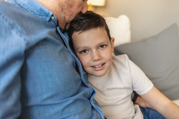 Dad, son and portrait in home for bonding, relax and relationship together with happiness or care. Man, child and face in living room for memory, support and weekend with smile, love and family trust.