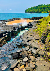 A hidden paradise where volcanic basalt rocks meet golden sands and turquoise waves. São Tomé and...