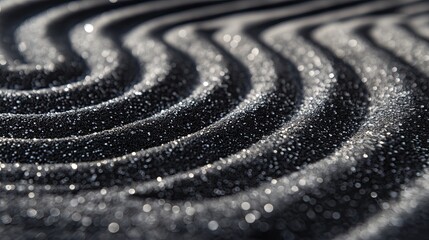 Black sand ripples creating a peaceful pattern.