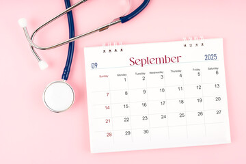 September 2025 desk calendar and stethoscope, Medical appointment schedule to check up.