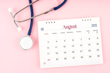 August 2025 desk calendar and stethoscope, Medical appointment schedule to check up.