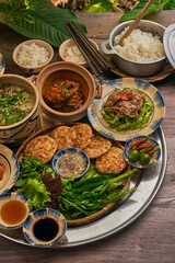 Traditional Vietnamese Food in wooden table with Green background
