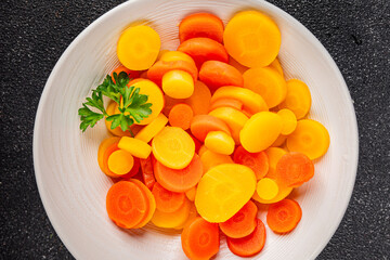 Carrot rings slice boiled vegetable dish fresh gourmet food background on the table rustic food top view copy space vegetarian and vegan food
