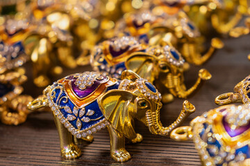 Intricately designed decorative elephant figurines, adorned with vibrant colors and gem details. The collection showcases ornate patterns and craftsmanship suitable for artistic displays and home deco