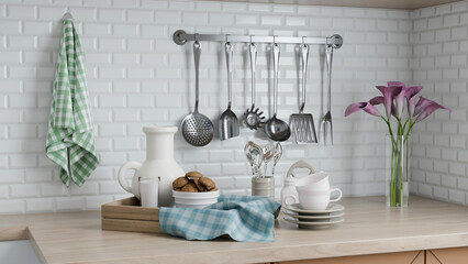 collection of stainless steel kitchen utensils hangs from a wall-mounted rack in a contemporary...