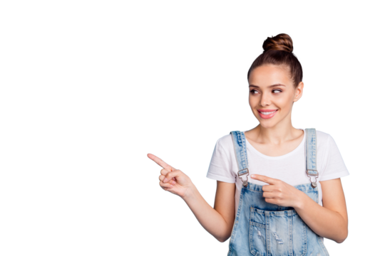 Portrait of cheerful lady looking at copy space wearing white t-shirt denim jeans isolated over blue background