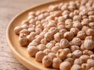 Raw Chickpeas on a rustic wooden table. Dry chickpea background close up. Chickpea legumes seed background.