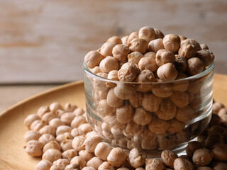 Raw Chickpeas on a rustic wooden table. Dry chickpea background close up. Chickpea legumes seed background.