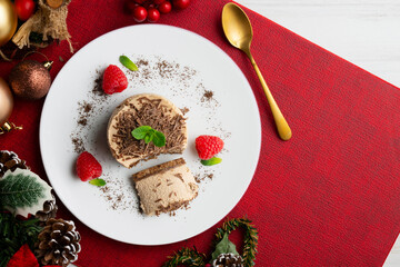 Chocolate and coffee mousse tartlets. Top view table with christmas decorations.
