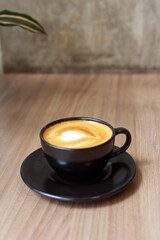 Coffee Cup with Heart Latte Art on Wooden Table