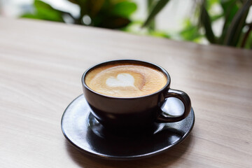 Coffee Cup with Heart Latte Art on Wooden Table