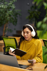 Elegant young woman immersed in work at a modern office during a productive day