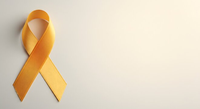 ai image A single yellow satin awareness ribbon lies flat on a plain light background, shot directly from above, offering ample copy space