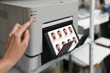 Worker using modern printer to print passport photos of man indoors, closeup