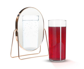 Red soda water in glass reflecting in mirror as clear, white background. Opposite, contrast,...