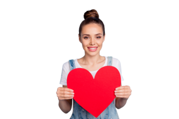 Portrait of pretty girl holding paper card gift for 14-february wearing white t-shirt denim jeans overalls isolated over blue background