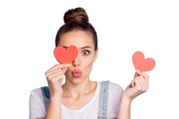 Close up of funky girl hide her eye with red paper card heart send air kisses wear white t-shirt denim jeans overalls isolated over blue background