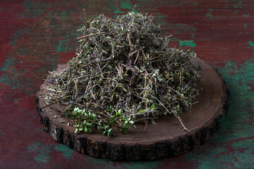 Dried herbs displayed on a rustic wooden board