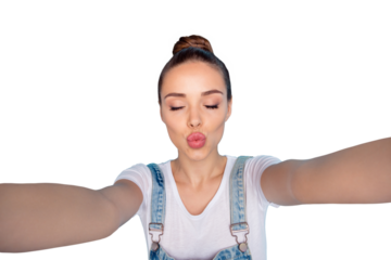 Self portrait of cute charming flirty tempting girl kissing you via camera while isolated with blue background